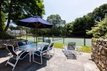 Bluestone patio with umbrellaed seating for 6 and two lounge chairs
